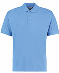 A Kustom Kit KK403 plain light blue polo shirt featuring a collar and three buttons displayed on a white background. This shirt has short sleeves and a classic fit.
