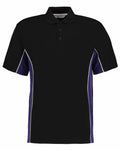Introducing the Gamegear KK475: a black polo shirt showcasing a three-button collar. It is enhanced with dark blue side panels, outlined by sleek thin white stripes, and presented on a simple white backdrop.