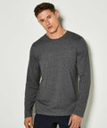 A person with short hair wearing a long-sleeved, dark gray KK510 shirt by Kustom Kit stands against a plain background.