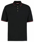 The Kustom Kit KK606 is a black polo shirt with a red-trimmed collar and sleeve edges, featuring a three-button placket.