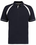 The Kustom Kit KK615 is a black polo shirt with short sleeves that showcases white accents on the shoulders and sleeve edges. It features a collared neckline and buttons down the front.