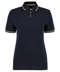 The Kustom Kit KK706 is a black polo shirt featuring yellow trim on the collar and sleeves, along with a three-button placket.