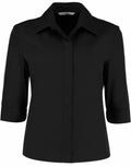 The KK715 by Kustom Kit is a black, long-sleeve button-up shirt featuring a collar and cuffed sleeves.