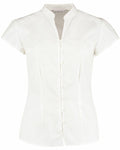 The KK727 by Kustom Kit is a white short-sleeved blouse featuring a mandarin collar and front button detailing.