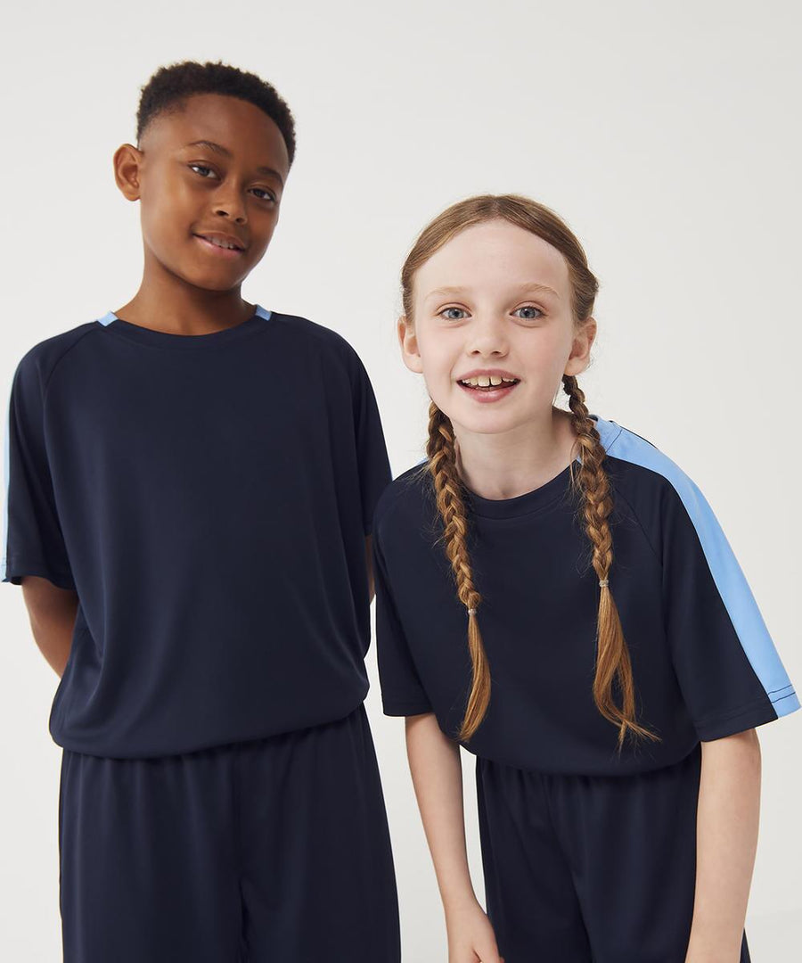 Two children wear matching Finden & Hales Kids team T-shirts against a plain background; the girl has plaited hair and blue striped sleeves, while the boy stands with his hands behind his back.