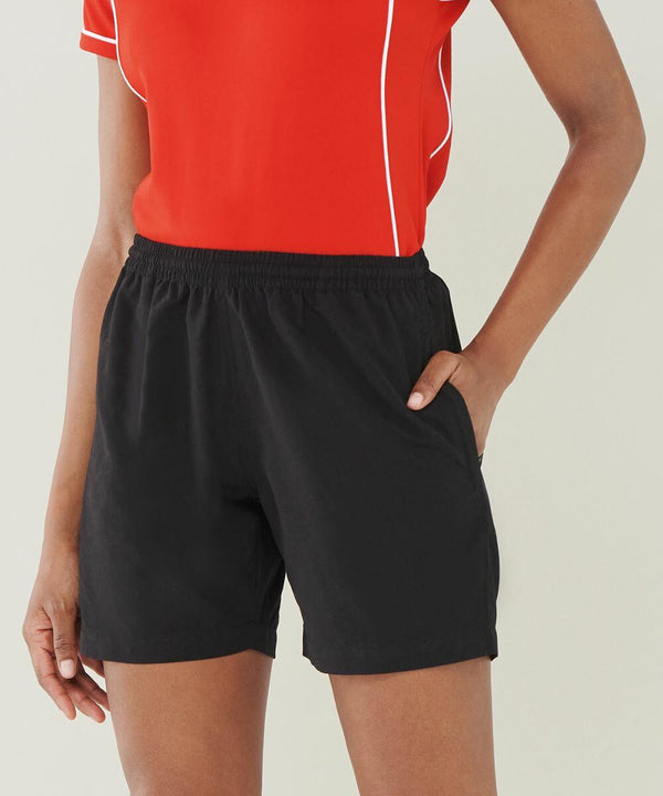 Person wearing a red shirt and black shorts with one hand in the pocket, dressed in Finden & Hales LV831.