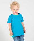 A young child with curly blonde hair is wearing a blue Larkwood LW20T T-shirt and blue jeans, standing against a plain white background.
