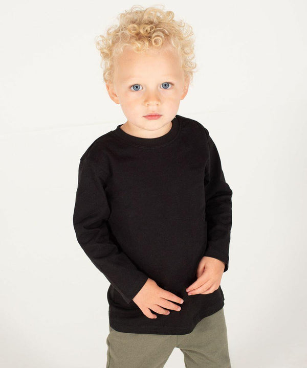 A young child with curly blond hair and blue eyes is wearing a black Larkwood LW21T long-sleeved shirt and green pants, standing against a plain white background.