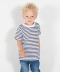 A young child with curly blonde hair wearing a Larkwood LW27T striped t-shirt and jeans stands against a plain background.