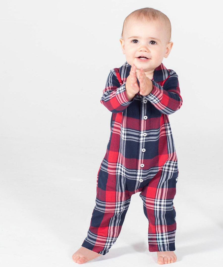 A toddler in a red and blue plaid Larkwood LW74T onesie stands on a white background, clapping their hands.