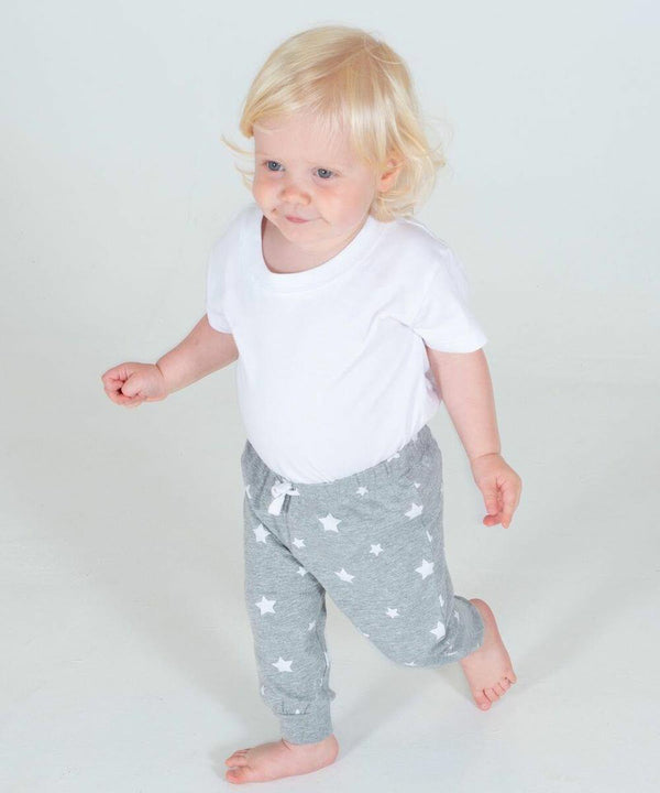 A toddler with blond hair wearing a white LW85T Larkwood shirt and gray star-patterned pants walks barefoot on a white background.