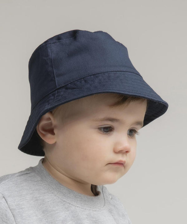 A young child wears the Larkwood Bucket hat in navy blue and a light grey shirt, looking slightly downward with a neutral expression against a plain background.