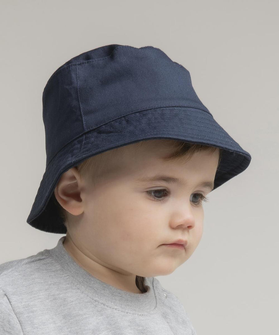 A young child wears the Larkwood Bucket hat in navy blue and a light grey shirt, looking slightly downward with a neutral expression against a plain background.