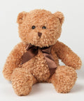 A fluffy brown teddy bear with a brown ribbon tied around its neck, seated against a plain white background, Mumbles MM003.