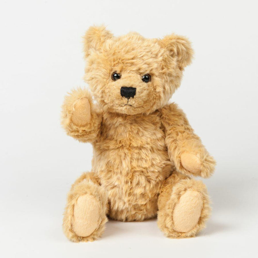 Product MM016 from Mumbles, a fluffy brown teddy bear, is positioned upright on a plain white background with one arm raised.