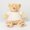 A plush teddy bear designed by Mumbles, featuring light brown fur and wearing a white shirt, is sitting upright against a plain background. Model number: MM021.