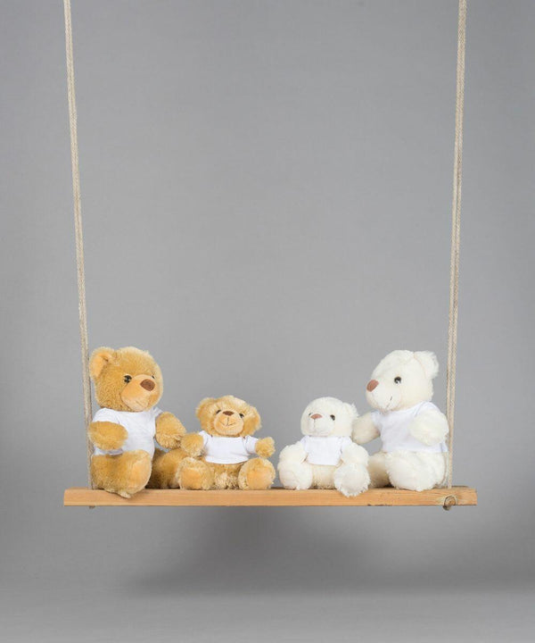 Four Mumbles MM030 teddy bears of different sizes, each wearing a white shirt, sit on a wooden swing against a plain gray background.