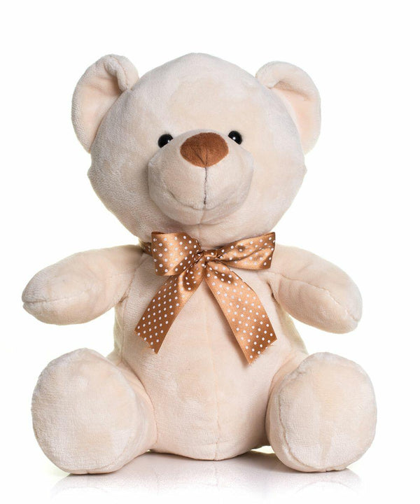 A beige Mumbles MM032 with a brown polka dot bow around its neck sits upright against a white background.