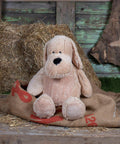Mumbles MM052 sits on burlap sack in front of hay bales and a weathered wooden wall.