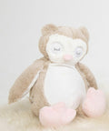 A soft, plush owl toy with closed eyes, beige and white body, small wings, and pink feet and beak. The Mumbles MM054 is set against a plain white background.