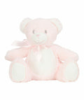 A Mumbles MM060 teddy bear in soft pink with a white belly and paws, showcasing a stitched smile, shiny eyes, and adorned with a pink satin ribbon around its neck, sits upright on a plain white background.