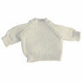 The Mumbles MM083 is a petite, light beige knitted sweater featuring long sleeves and a ribbed neckline, cuffs, and hem.