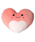 Soft Toys offers a plush, heart-shaped light pink cushion featuring a white heart, smiling face with black eyes, pink cheeks, and a small curved mouth.