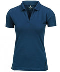 The Nimbus NB52F is a women's polo shirt featuring a dark blue color, short sleeves, and a v-neck collar. It is crafted from soft material and offers a slim fit design.