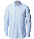 The Nimbus NB66M is a light blue button-up long-sleeve shirt with a classic collar, displayed against a plain white background.