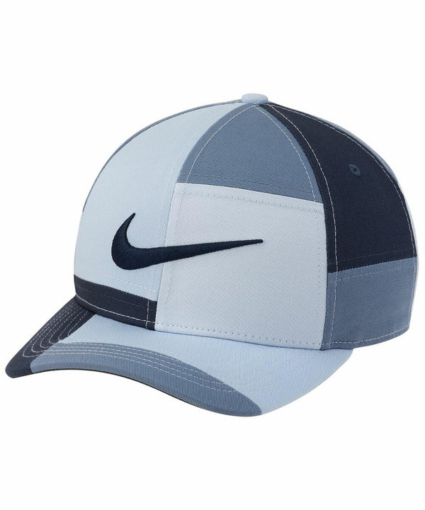 A blue, multi-tone baseball cap with a curved brim and a navy Nike swoosh logo on the front, called the NK324 by Nike.