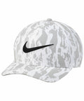A gray and white camouflage-patterned baseball cap with a black Nike swoosh logo on the front from the Nike NK325 collection.