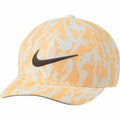 A Nike cap, model NK325, featuring an orange and white abstract pattern with a black swoosh logo on the front.