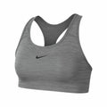 Nike's NK379 sports bra in gray showcases a black logo on the front and features a racerback design.