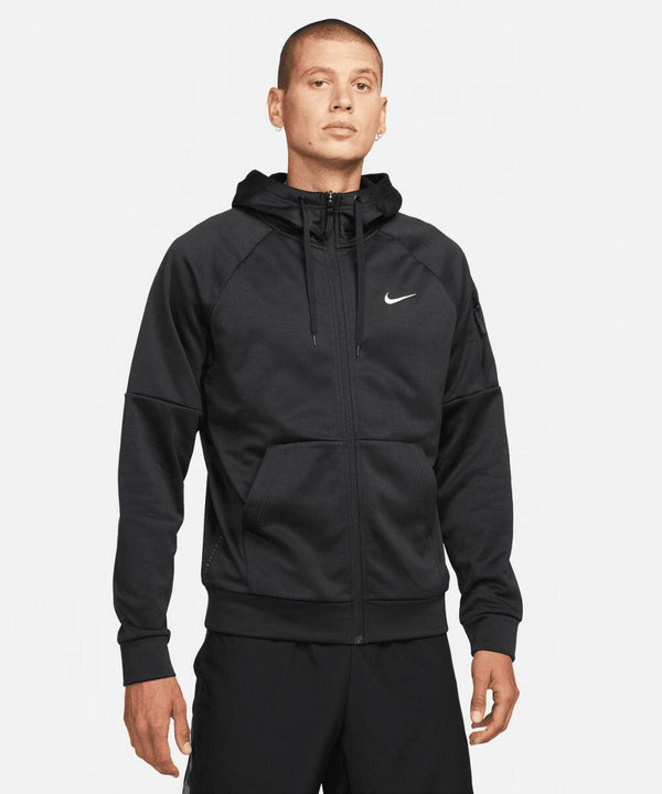A person wearing a black NK389 zip-up hoodie with a white Nike logo on the chest. They are standing against a plain white background.