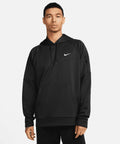 A man wearing a black Nike NK391 hoodie with a white Nike logo on the chest and black pants stands against a plain white background.