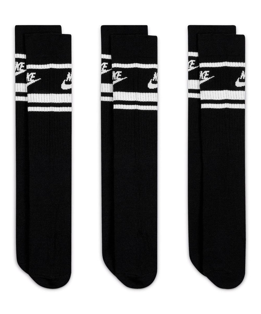 Three pairs of black socks with white stripes and the Nike logo near the top, displayed upright against a white background. Product: Socks.