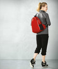 Person dressed in activewear carrying an OG026 drawstring bag by Ogio, walking away from the camera.