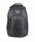 The OG036 from Ogio is a gray and black backpack featuring a top handle, zipper compartments, and a logo on the front.