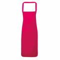 Displayed against a white background is the PR102 apron by Premier, featuring a bright pink color and a square neckline. Its design is sleek and simple, without any visible pockets or patterns.
