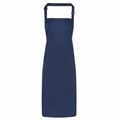 A Premier PR115 apron featuring a plain dark blue design with adjustable neck straps, displayed against a white background.