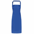 The PR115 by Premier is a straightforward and practical apron in plain blue, featuring a neck loop and waist ties, showcased against a white background.
