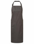 A Premier PR120 apron featuring a plain black design, two pockets, and an adjustable neck strap.