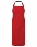 The PR120 by Premier is a solid red apron featuring an adjustable neck strap and two spacious front pockets. It boasts a simple, clean design, making it ideal for cooking or crafting. The fabric is durable and practical for various activities.