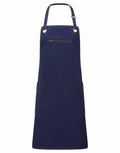 The Premier PR121 apron in navy blue features a convenient front zipper pocket and two side pockets.