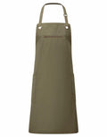The Premier PR121 is a khaki green apron featuring an adjustable neck strap with grommet details, along with a front zipper pocket and two large pockets.