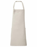 The Premier PR122 is a plain beige apron featuring neck and waist ties along with two large front pockets, elegantly displayed on a white background.