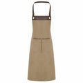 Premier's PR123 apron features a brown design with leather straps and two front pockets.