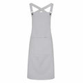 The Premier PR129 apron is featured in a light gray color, complete with a front pocket and cross-back straps. Displayed against a white background, it highlights its straightforward and elegant design, ideal for use in the kitchen or for craft activities.