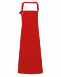 Introducing the PR130 from Premier: a sleek red apron with a neck strap, featuring a small loop on the upper left side, ideal for kitchen use. This apron boasts a simple yet elegant design, perfect for cooking or baking activities.