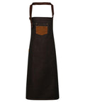 A Premier apron, model PR136, featuring a black fabric with a brown neck strap and chest pocket, showcased against a white background.